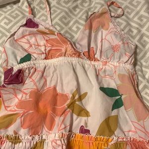 Shirt with some flower designs, the straps are skinny.